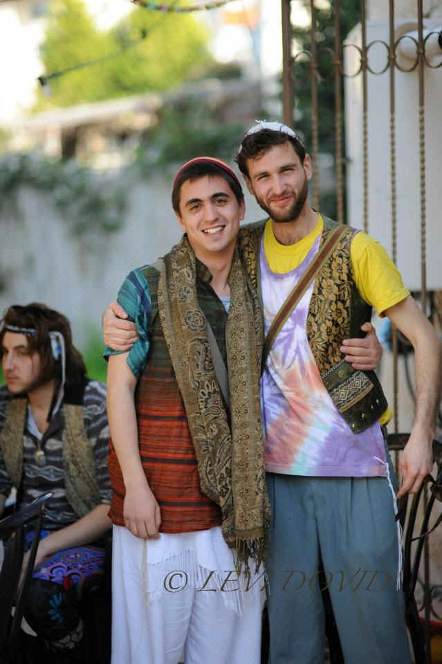 Wearer showing off tie-dye tzitzit