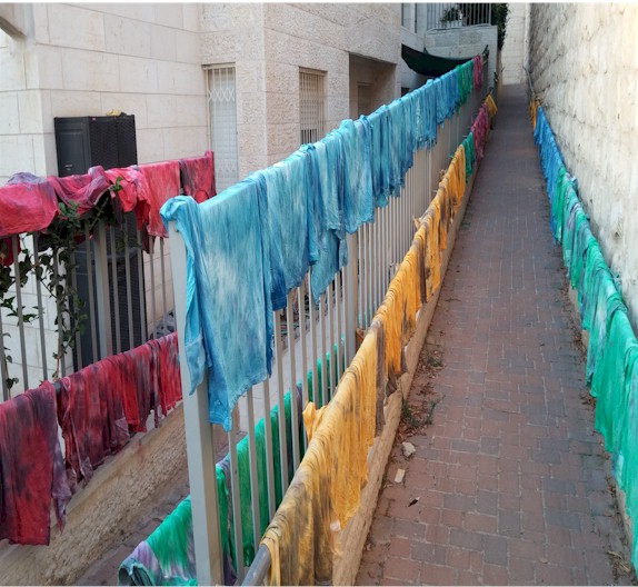 Pile of finished tie-dye tzitzit garments